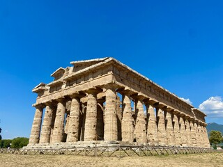 The Magnificent Ancient Greek Temple of Hera in Paestum, Italy, Showcasing Doric Architecture Under a Vibrant Blue Sky