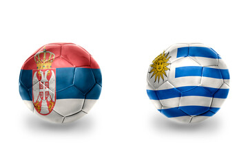 Obraz premium football balls with national flags of serbia and uruguay ,soccer teams. on the white background.