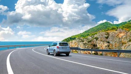 Selbstklebende Fototapeten Mediterranes Europa car drive on the road of mediterranean beach. driving on coast of ocean. Highway view on beach on way to summer holiday. Europe travel trip in sea coast road landscape. driving on the highway  © ZEHRA