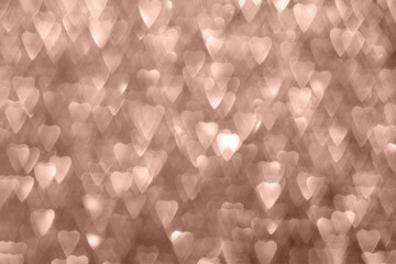 Hearts, sparkling bokeh, abstract defocused background in 2025 color mocha mousse