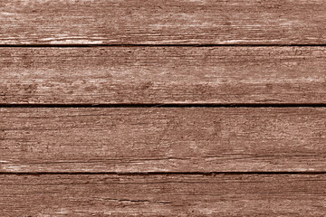 Vintage wooden background with peeling red paint. Fashionable colored mocha mousse 2025