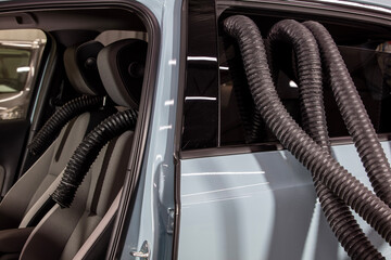 Professional Car Seat Dryer Hot Air Producer Octopus. Service car wash express. Worker uses turbo...