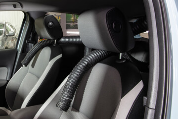 Professional Car Seat Dryer Hot Air Producer Octopus. Service car wash express. Worker uses turbo dryer to remove water drops. Detailing, car wash and paint correction concept.