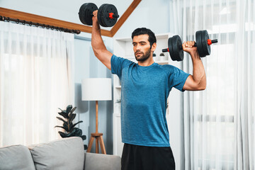 Athletic body and active sporty man lifting dumbbell weight for effective targeting muscle gain at...