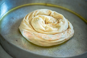 Elderly Woman Rolling Out Dough