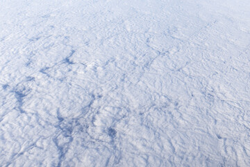 background showing the texture of clouds viewed from above, shot from an airplane window
