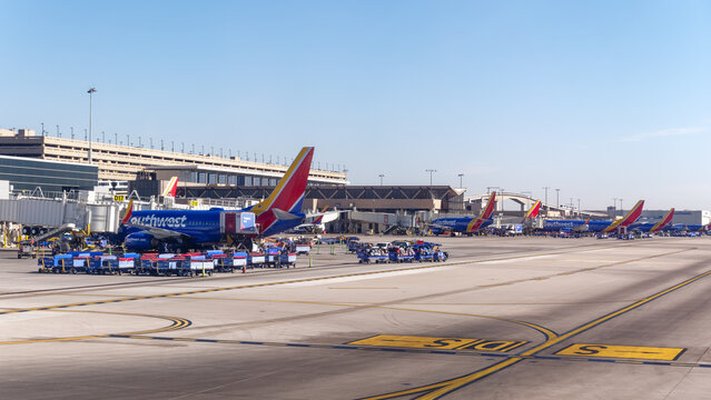 Phoenix, Arizona - Dec. 3, 2024: D gates at Phoenix Sky Harbor airport with Southwest Airline planes as viewed from the taxiway