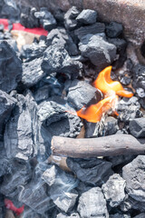 flame in carbon charcoal burning on a grill before cooking the meal