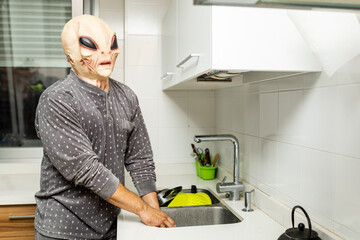 Photograph of a Martian dressed in pajamas doing everyday things in a house.The alien looks at the...