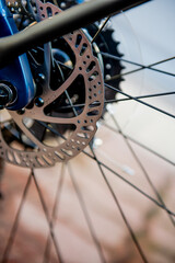 Bicycle disk brakes close up, grey metal disc attached to bike wheel. Hydraulic disk brakes on...