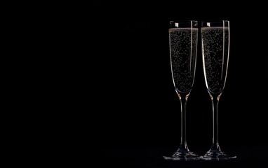 New Year's Eve toast, champagne glasses with sparkling glitter against a black background, copy space for text Generative AI
