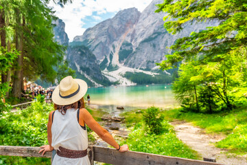 Tourist admiring stunning lake braies in the italian dolomites during summer