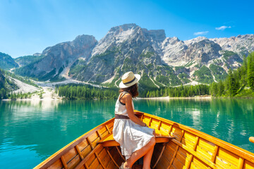 Tourist enjoying breathtaking view of lake braies in dolomites, italy