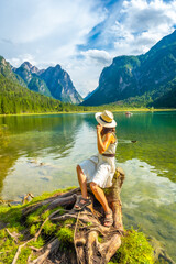 Tourist relaxing at lake dobbiaco enjoying the dolomites in summer