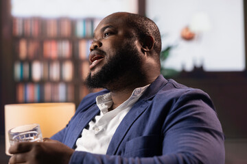Black entrepreneur discuss a promising business venture over whiskey in an old money style club, embodying elite social networking between huge estate heirs. Upper class society members.