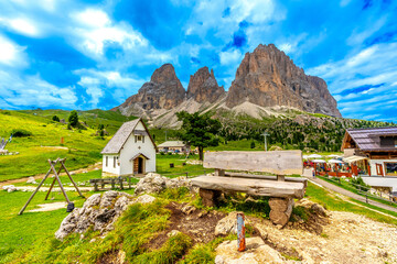 Wooden bench overlooking the sella pass in the dolomites, italy
