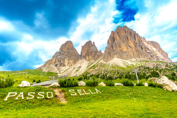 Passo sella sign with sassolungo group in the dolomites, italy