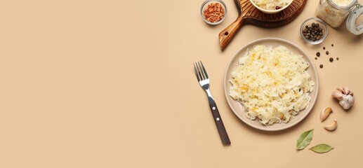 Plate of tasty sauerkraut and spices on beige background with space for text, top view
