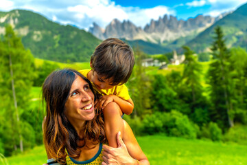 Mother and son enjoying the view of the dolomites in summer