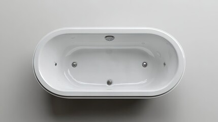 A sleek and modern white oval bathtub with chrome accents viewed from above in a minimalist setting.