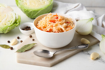 Bowl with tasty sauerkraut and cabbage on table