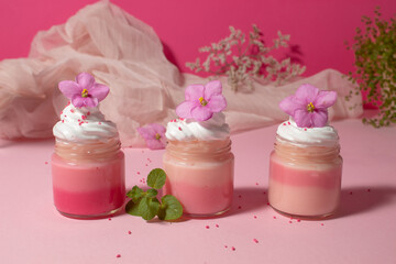 Pink cream with whipped cream and violets. Sweet love food. Still life