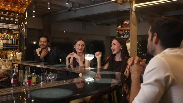 Bartender serving Margarita cocktail savoring sour tasty drink to woman customer drinking with couple or group friend at luxurious bar creating happiness moment meeting at vibrant nightclub. Vinosity.