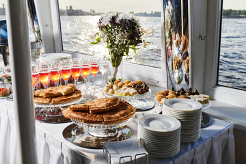 An Elegant Banquet Table Setup Gracefully Arranged on a Charming Scenic Boat Experience