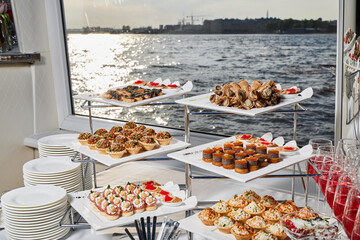 An Elegant and Stunning Buffet Display Harmoniously Complemented by a Scenic Water View