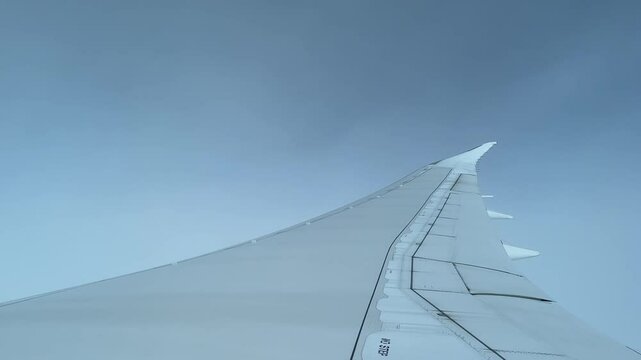 AERIAL VIEWS FROM INSIDE AN AIRPLANE TO THE EXTERIOR