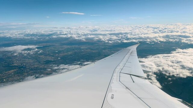 AERIAL VIEWS FROM INSIDE AN AIRPLANE TO THE EXTERIOR