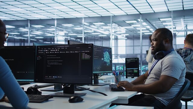 Happy computer scientist working in data center providing computing resources for different workloads. Cheerful IT specialist monitoring high tech supercomputers using tablet, camera B