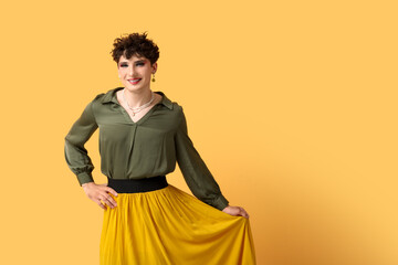 Young transgender woman on yellow background
