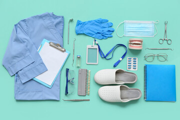 Medical supplies with uniform and dental instruments on turquoise background. Top view