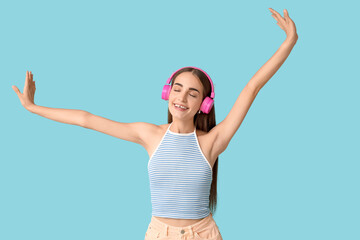 Young woman in headphones with diastema on blue background