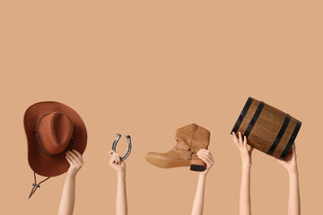 Female hands with cowboy hat, shoe, horseshoe and barrel on color background