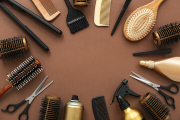 Frame made of hairdresser's accessories on brown background