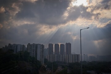 Fototapeta premium Dramatic Urban Landscape with Sunlight and Clouds