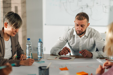 Business team analyzing marketing data and planning strategy during a meeting