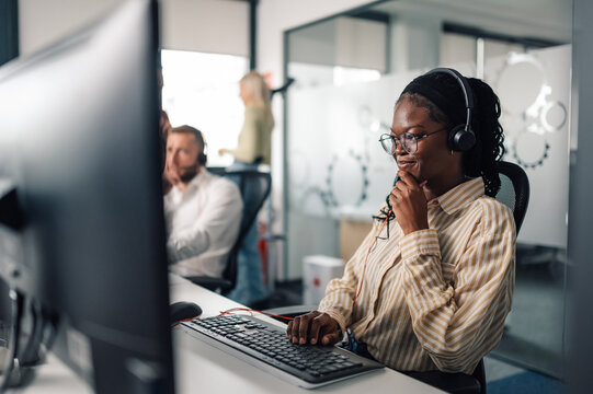 Customer service representative working in busy call center office