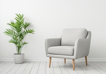 A comfortable grey armchair with wooden legs sits next to a potted plant in a minimalist living room with white walls and wooden floorboards