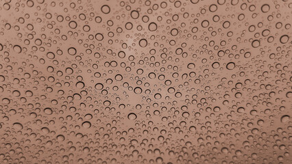 Colour of the year Mocha Mousse. Abstract image of rain drops on glass is toned in brown. New Fashion colour. Top view. Abstract drops view.