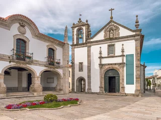 Facade of Mercy Church with Renaissance entrance portal and door open, pediment with saint and bell tower, Caminha, Viana do Castelo district, north of Portugal