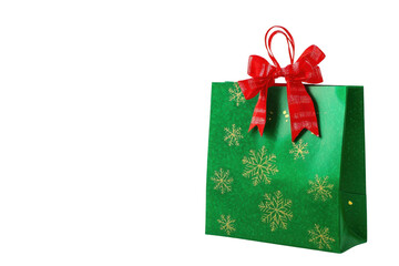 A vibrant gift bag decorated with golden snowflakes and a striking red bow, perfect for Christmas celebrations and holiday gifting. Ideal for creating a joyful and festive atmosphere.