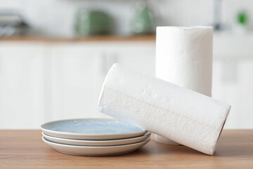 Rolls of paper towels with plates on kitchen table