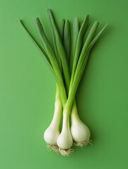 Fresh, raw garlic cloves on green background.