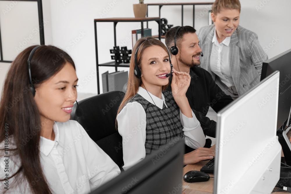Poster team of technical support agents working at table in office