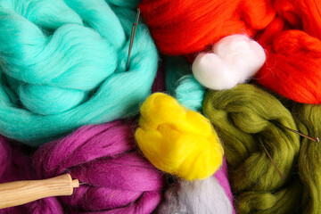 Different wool for felting with needles as background, closeup © Pixel-Shot