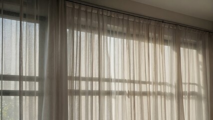 Sunlight streaming through sheer curtains in serene room