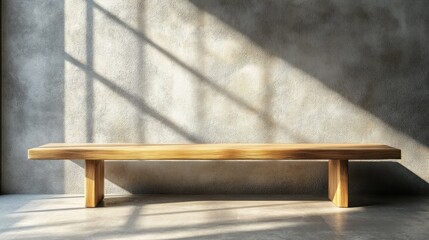Minimalist wooden bench against a textured wall with shadows.